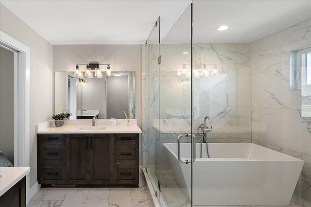 full bath with marble finish floor, a freestanding bath, and vanity