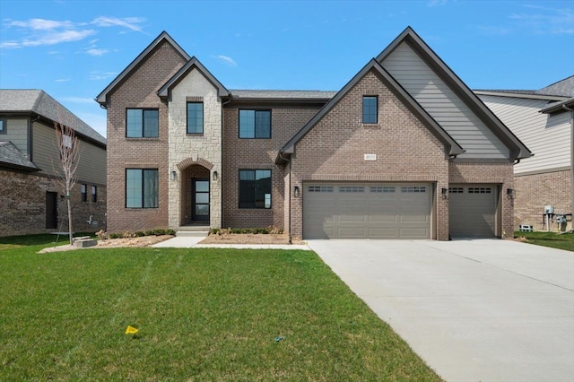 traditional-style house with brick siding, an attached garage, a front yard, and concrete driveway