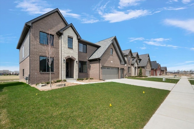 traditional-style home featuring brick siding, driveway, a front yard, and a garage