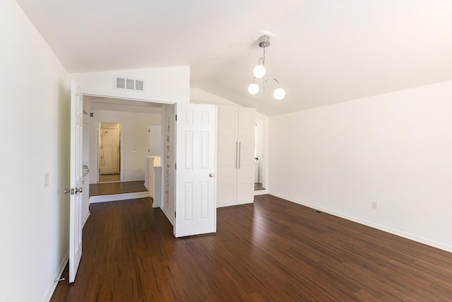 3029 Turnberry Ln, Ann Arbor, MI 48108 - unfurnished room with dark wood finished floors, vaulted ceiling, visible vents, and baseboards