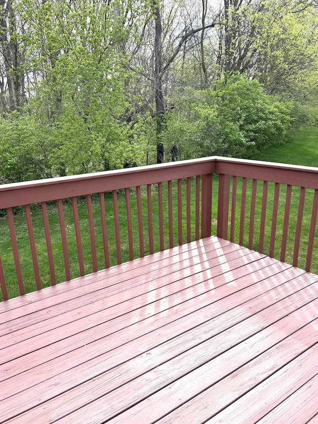 wooden terrace featuring a yard