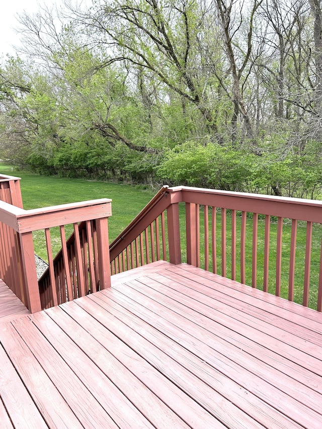 wooden deck with a lawn