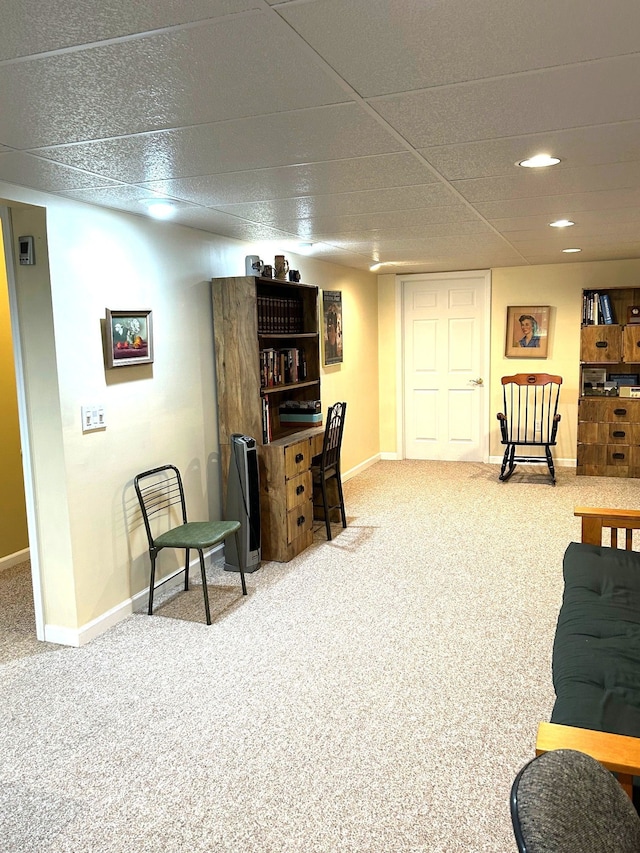 living area featuring baseboards and carpet flooring