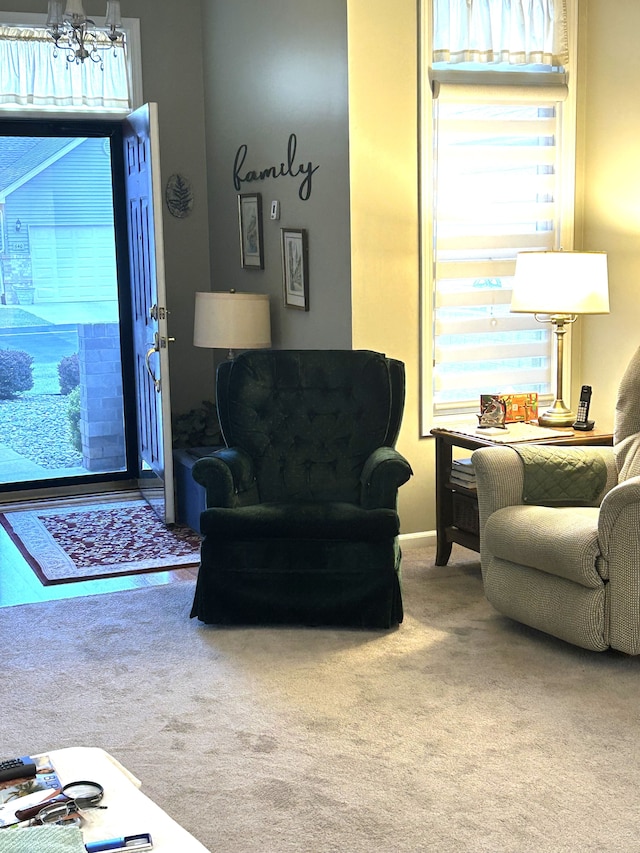 carpeted living area featuring a notable chandelier