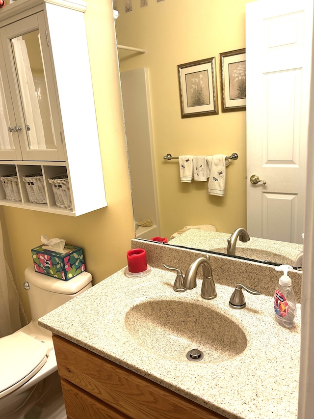 bathroom featuring vanity and toilet