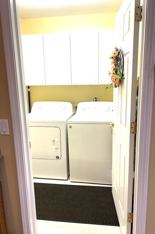 laundry area featuring cabinet space and independent washer and dryer