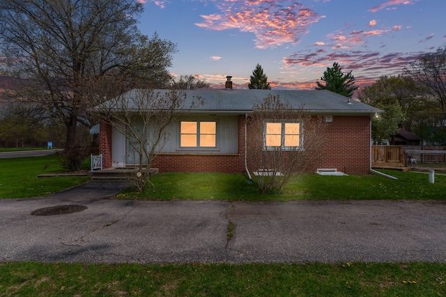 1401 S Williams Lake Rd, Waterford, MI 48327 - view of front of property with a chimney, brick siding, and a yard