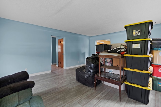 1401 S Williams Lake Rd, Waterford, MI 48327 - living area featuring wood finished floors, baseboards, and a textured ceiling
