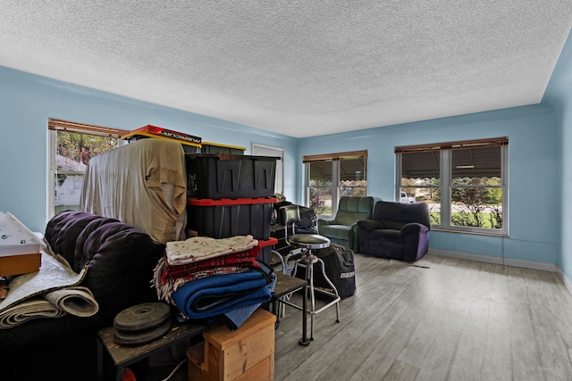 1401 S Williams Lake Rd, Waterford, MI 48327 - living area featuring wood finished floors, a textured ceiling, and baseboards