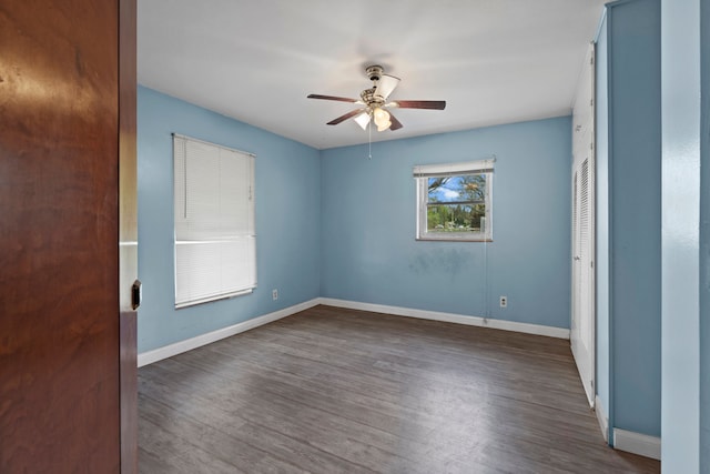 1401 S Williams Lake Rd, Waterford, MI 48327 - unfurnished bedroom featuring baseboards, wood finished floors, and a ceiling fan