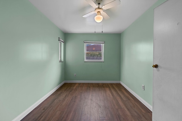 1401 S Williams Lake Rd, Waterford, MI 48327 - unfurnished room featuring dark wood-style flooring, ceiling fan, and baseboards