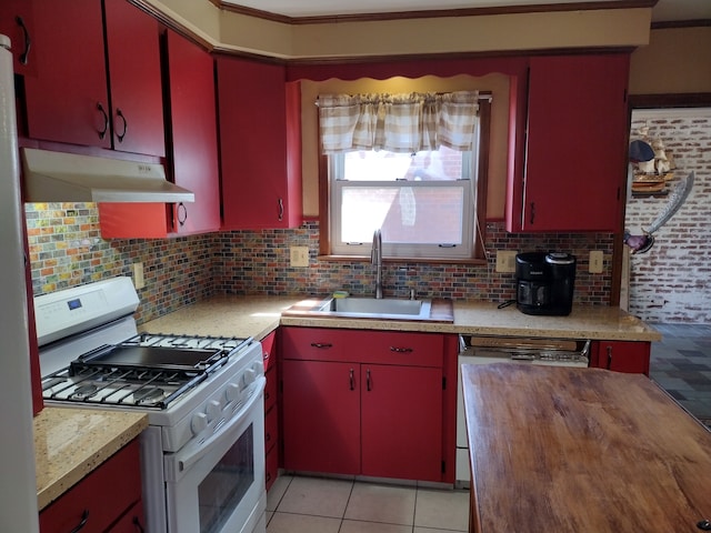 1981 Westfield Rd, Trenton, MI 48183 - kitchen with a sink, decorative backsplash, under cabinet range hood, red cabinets, and gas range gas stove