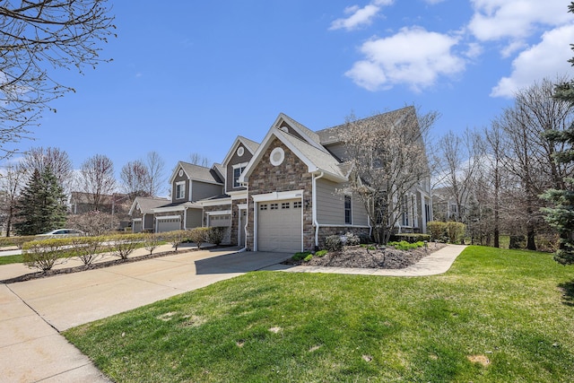 view of home's exterior featuring concrete driveway, a yard, and stone siding