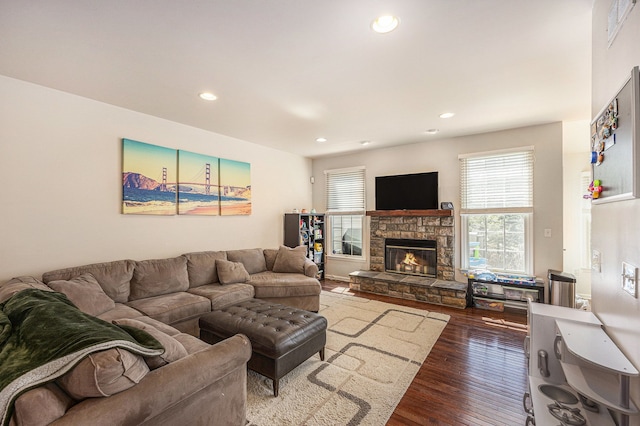 living room with recessed lighting, visible vents, hardwood / wood-style floors, and a fireplace
