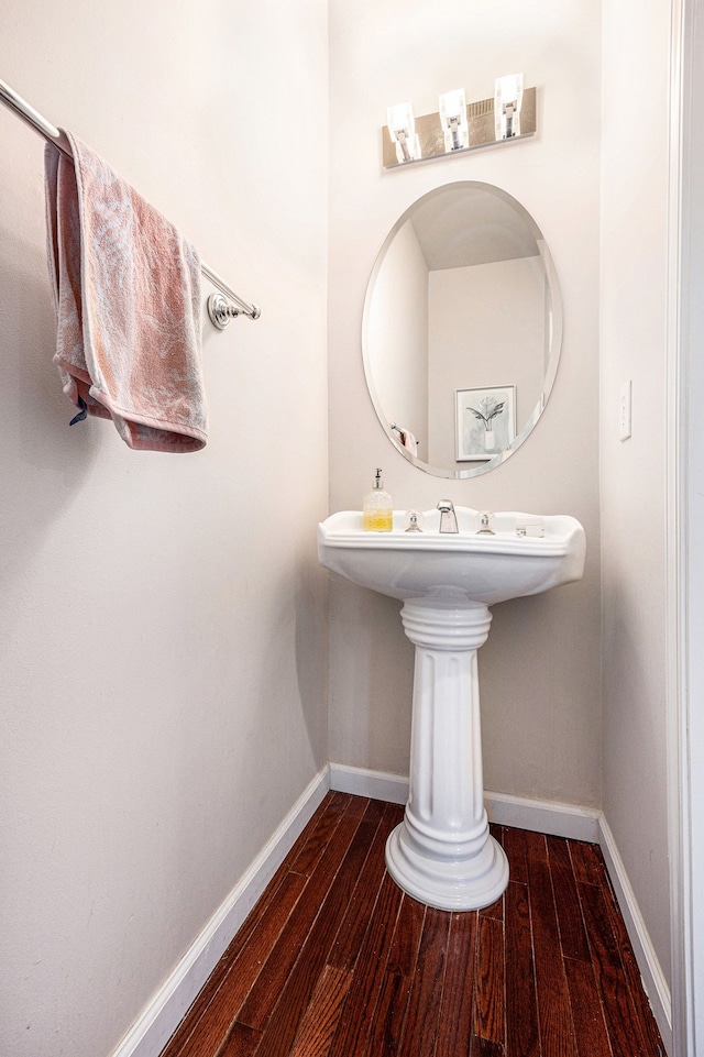 bathroom with wood finished floors and baseboards