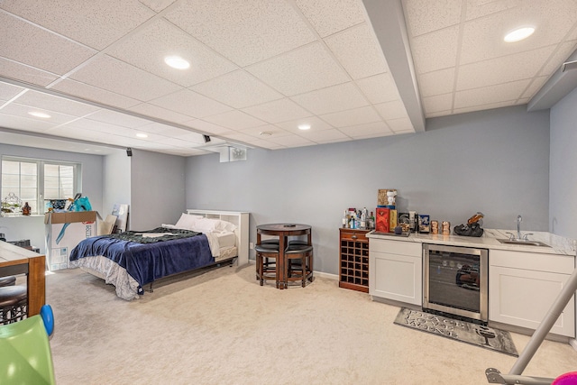 bedroom with beverage cooler, recessed lighting, light carpet, a sink, and wet bar