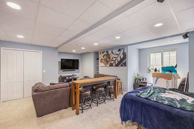 carpeted bedroom with a drop ceiling and recessed lighting