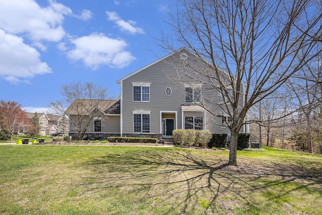 view of front of property with cooling unit, a front yard, and stone siding