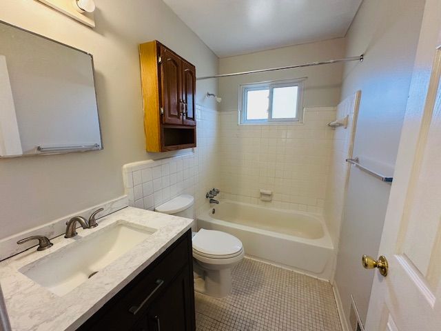 819 Frank Ave, Lincoln Park, MI 48146 - bathroom featuring tub / shower combination, vanity, toilet, and tile patterned flooring
