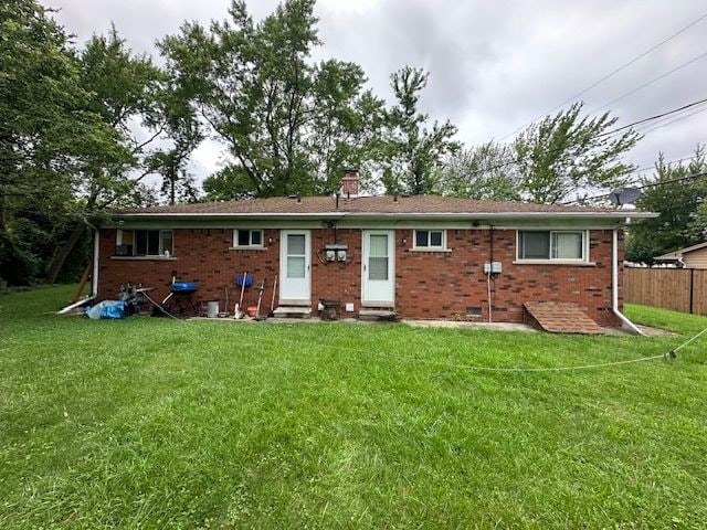 819 Frank Ave, Lincoln Park, MI 48146 - rear view of property with brick siding, fence, entry steps, and a yard