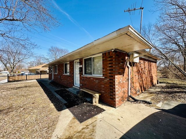 819 Frank Ave, Lincoln Park, MI 48146 - exterior space featuring brick siding and fence
