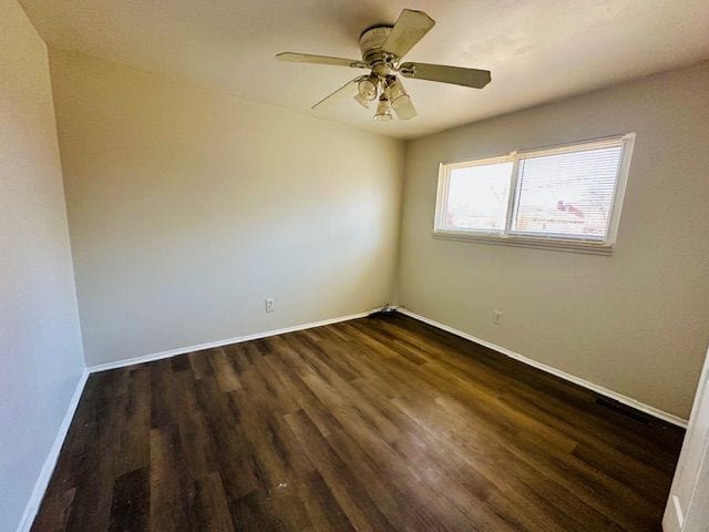 819 Frank Ave, Lincoln Park, MI 48146 - unfurnished room with a ceiling fan, dark wood finished floors, and baseboards
