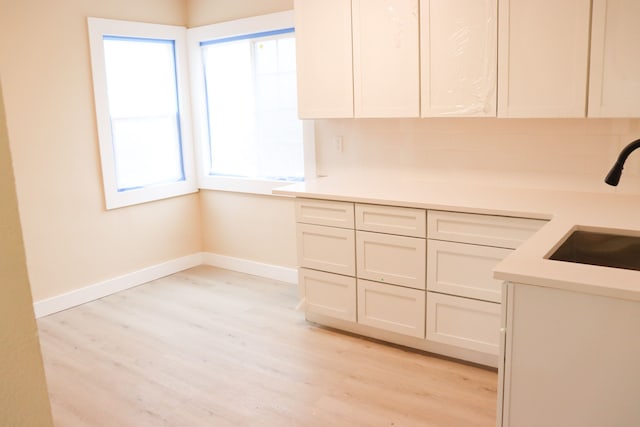 1338 Helen St, Inkster, MI 48141 - kitchen featuring baseboards, a sink, light wood finished floors, and light countertops