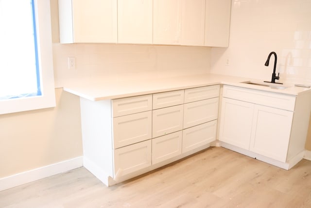 1338 Helen St, Inkster, MI 48141 - kitchen with a sink, light countertops, tasteful backsplash, and light wood finished floors