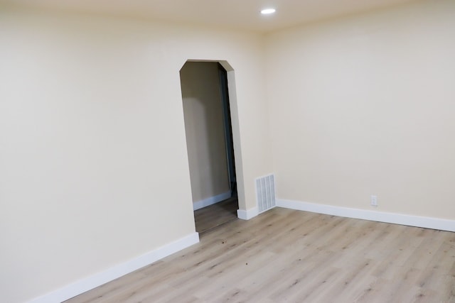 1338 Helen St, Inkster, MI 48141 - unfurnished room featuring visible vents, baseboards, recessed lighting, arched walkways, and light wood-style flooring
