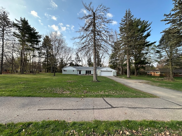 view of front of house with aphalt driveway and a front yard