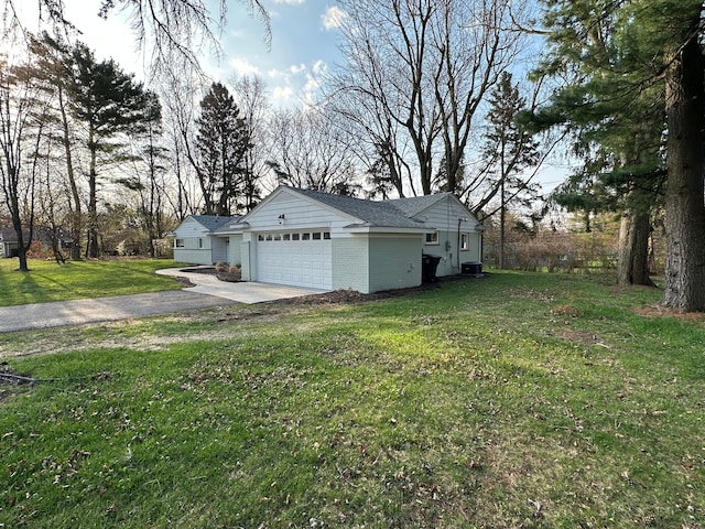 garage featuring driveway and central AC unit