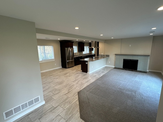 kitchen with freestanding refrigerator, open floor plan, visible vents, and recessed lighting