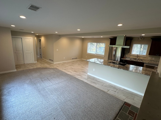 kitchen featuring visible vents, recessed lighting, stone countertops, and a sink