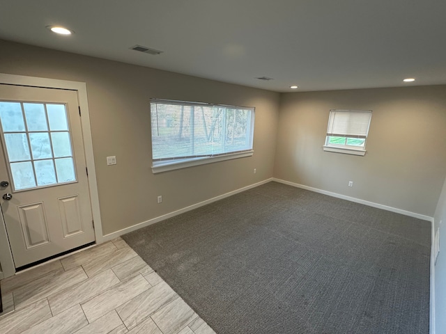 interior space featuring baseboards, visible vents, a wealth of natural light, and recessed lighting
