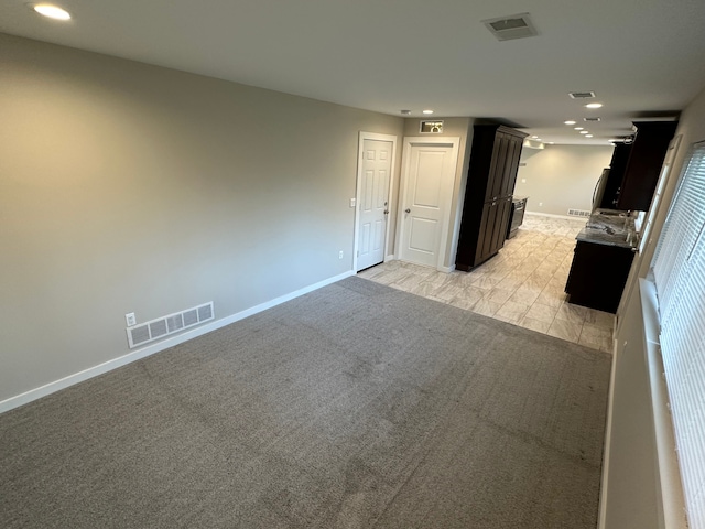 interior space with light carpet, visible vents, and recessed lighting