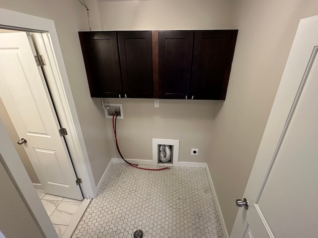 washroom featuring electric dryer hookup, baseboards, washer hookup, and cabinet space