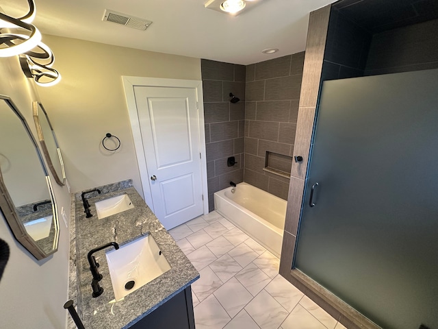 full bath with double vanity, visible vents, marble finish floor, and a sink
