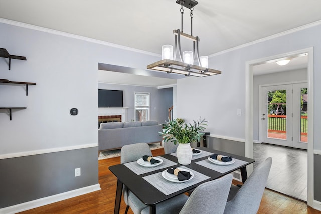 11310 Ingram St, Livonia, MI 48150 - dining space with crown molding, wood finished floors, and a chandelier