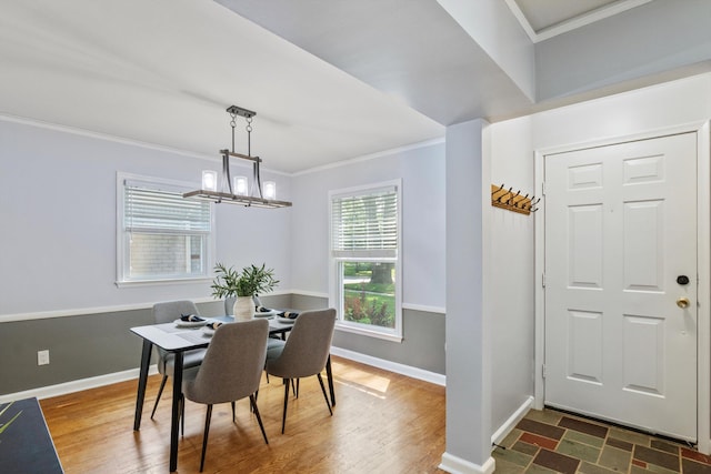 11310 Ingram St, Livonia, MI 48150 - dining area with ornamental molding, a chandelier, and dark wood-style flooring