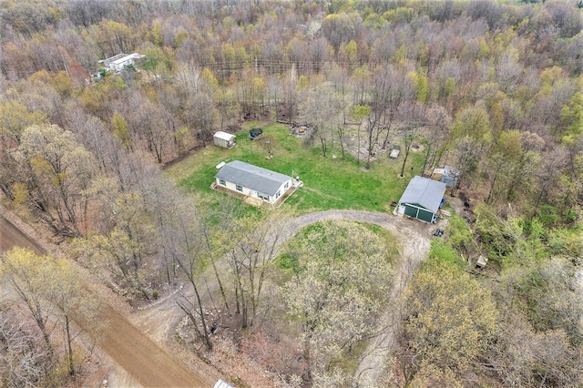 bird's eye view with a wooded view