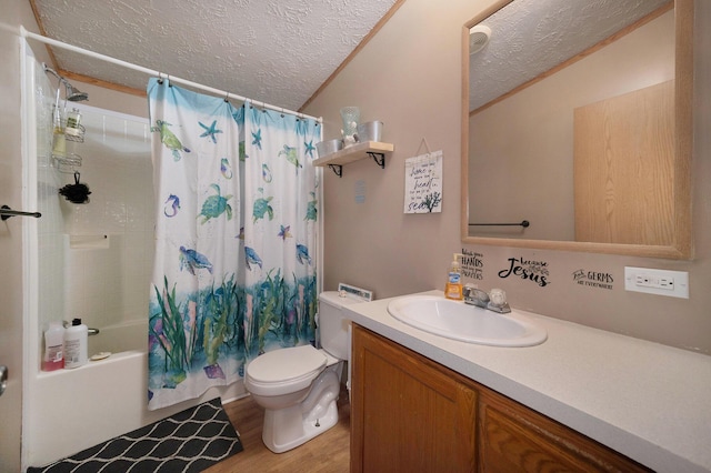 full bath with wood finished floors, a textured ceiling, vanity, and toilet