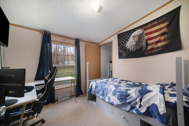 bedroom featuring lofted ceiling, a textured ceiling, visible vents, and carpet