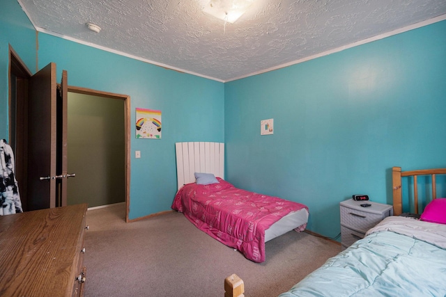 carpeted bedroom featuring a textured ceiling and crown molding