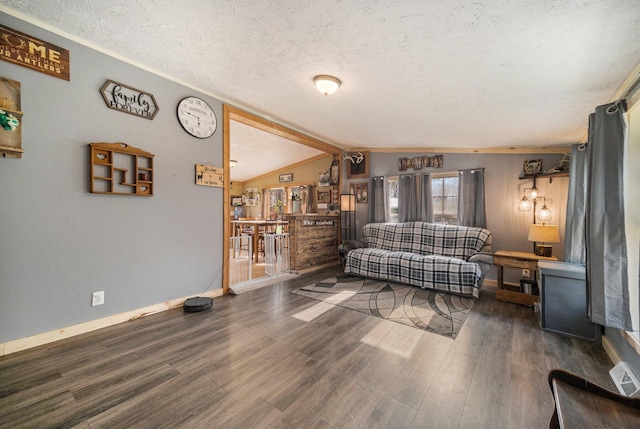 living area with lofted ceiling, baseboards, wood finished floors, and a textured ceiling