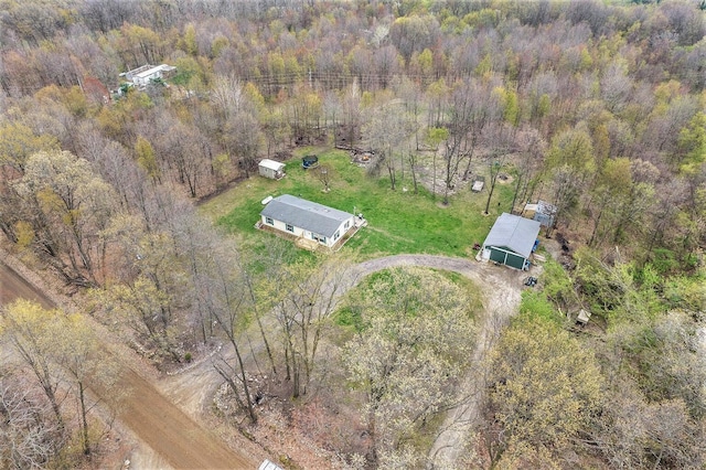 birds eye view of property with a forest view
