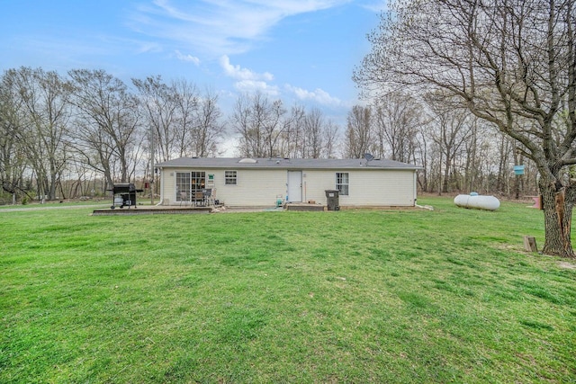 rear view of property with a lawn