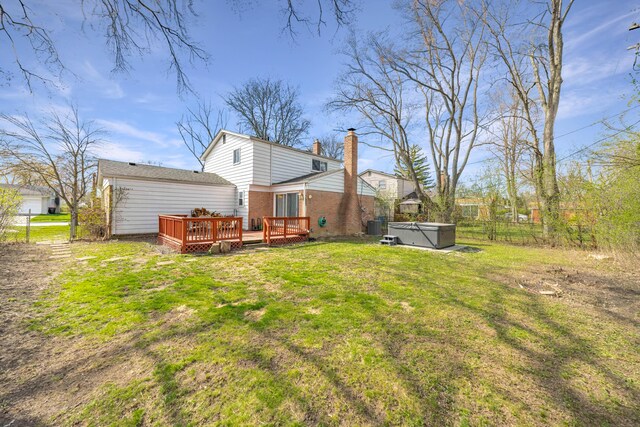 29772 Brentwood St, Southfield, MI 48076 - back of house with a chimney, a lawn, fence, a hot tub, and a wooden deck