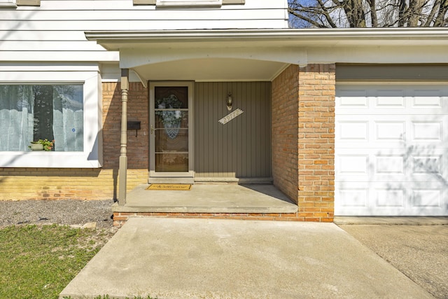 29772 Brentwood St, Southfield, MI 48076 - property entrance featuring an attached garage, brick siding, driveway, and covered porch