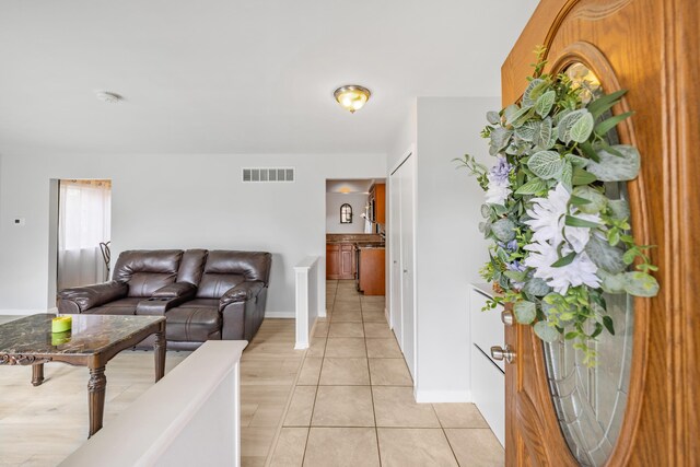 29772 Brentwood St, Southfield, MI 48076 - living room featuring baseboards, visible vents, and light tile patterned floors