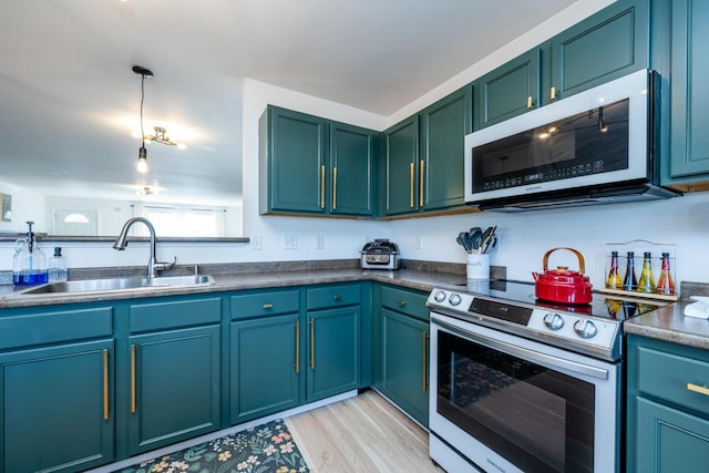 1216 Ellery Grove Ct, Vicksburg, MI 49097 - kitchen featuring a sink, electric range, light wood-type flooring, white microwave, and pendant lighting